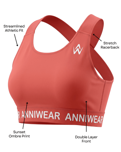 Coral sports bra with ANNIWEAR branding, labelled features on a white background