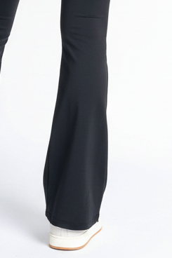 Black pants worn by a person on a white background