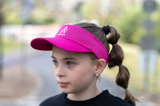 Girl wearing a Sports Sun Visor in Fuscia color